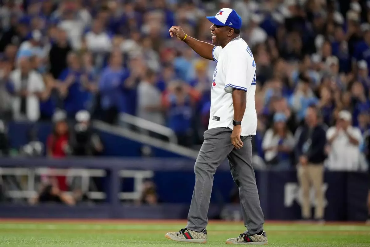 Joe Carter throws out the ceremonial first pitch before Game 2 of baseball's World Series between the Los Angeles Dodgers and the Toronto Blue Jays, Saturday, Oct. 25, 2025, in Toronto. (AP Photo/Brynn Anderson)
