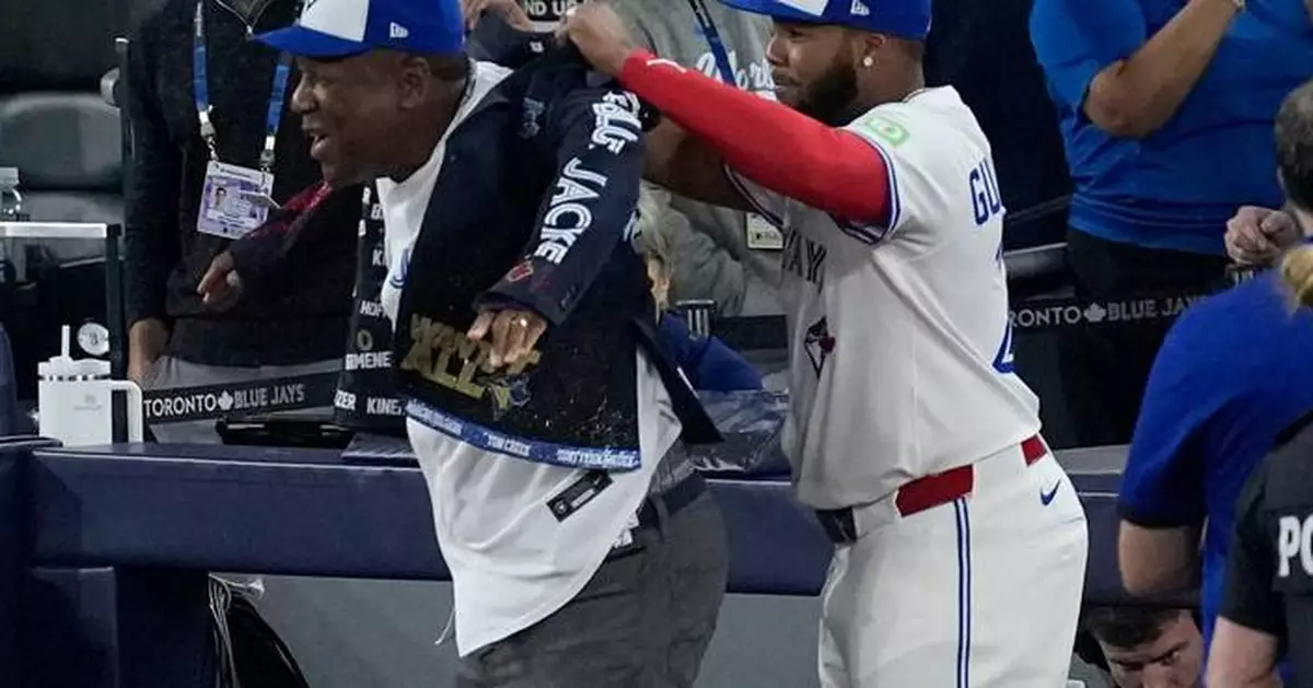 Joe Carter wears Blue Jays' home run jacket after throwing first pitch at World Series Game 2