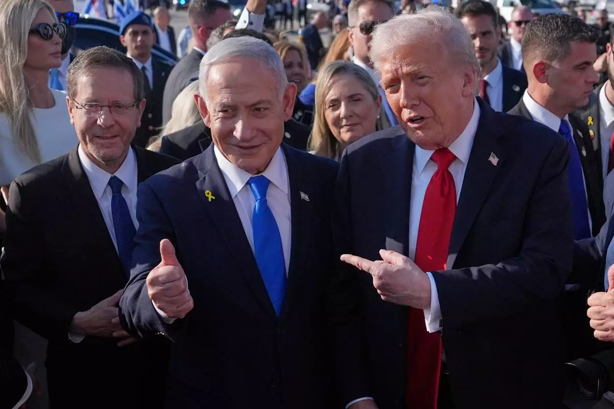 FILE - President Donald Trump poses for a photo with Israel's Prime Minister Benjamin Netanyahu before he boards Air Force One at Ben Gurion International Airport, Monday, Oct. 13, 2025, near Tel Aviv, as Israel's President Isaac Herzog watches at left. (AP Photo/Evan Vucci, File)