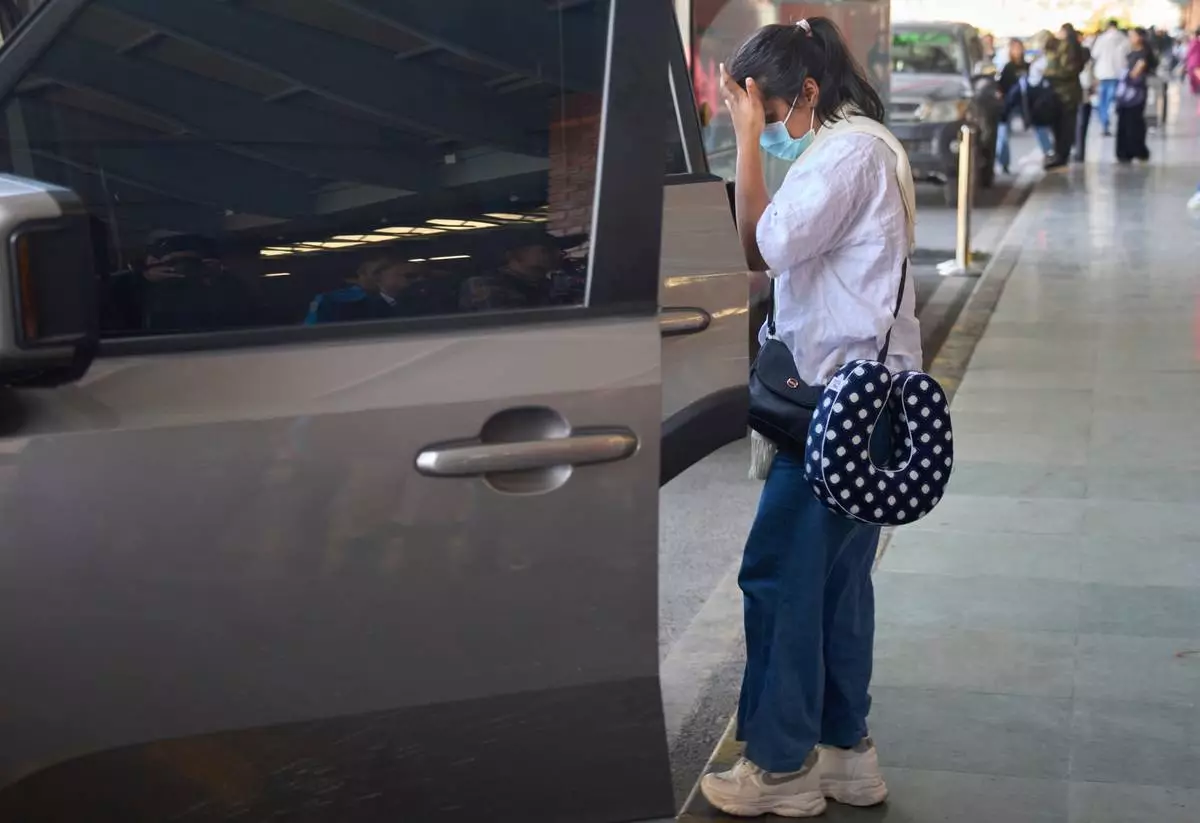 Pushpa Joshi, sister of Bipin Joshi, a Nepali man who was taken hostage by Hamas on Oct. 7, 2023, and was recently declared dead, arrives from the U.S. at Tribhuvan international airport in Kathmandu, Nepal, Thursday, Oct. 16, 2025. (AP Photo/Niranjan Shrestha)