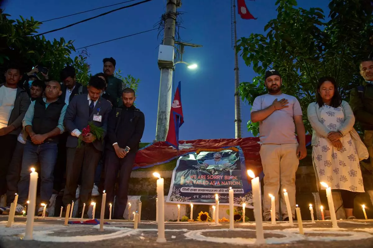 People participate in a candlelight vigil for Bipin Joshi, a Nepali man who was taken hostage by Hamas on Oct. 7, 2023, and was recently declared dead, in Kathmandu, Nepal, Wednesday, Oct. 15, 2025. (AP Photo/Niranjan Shrestha)