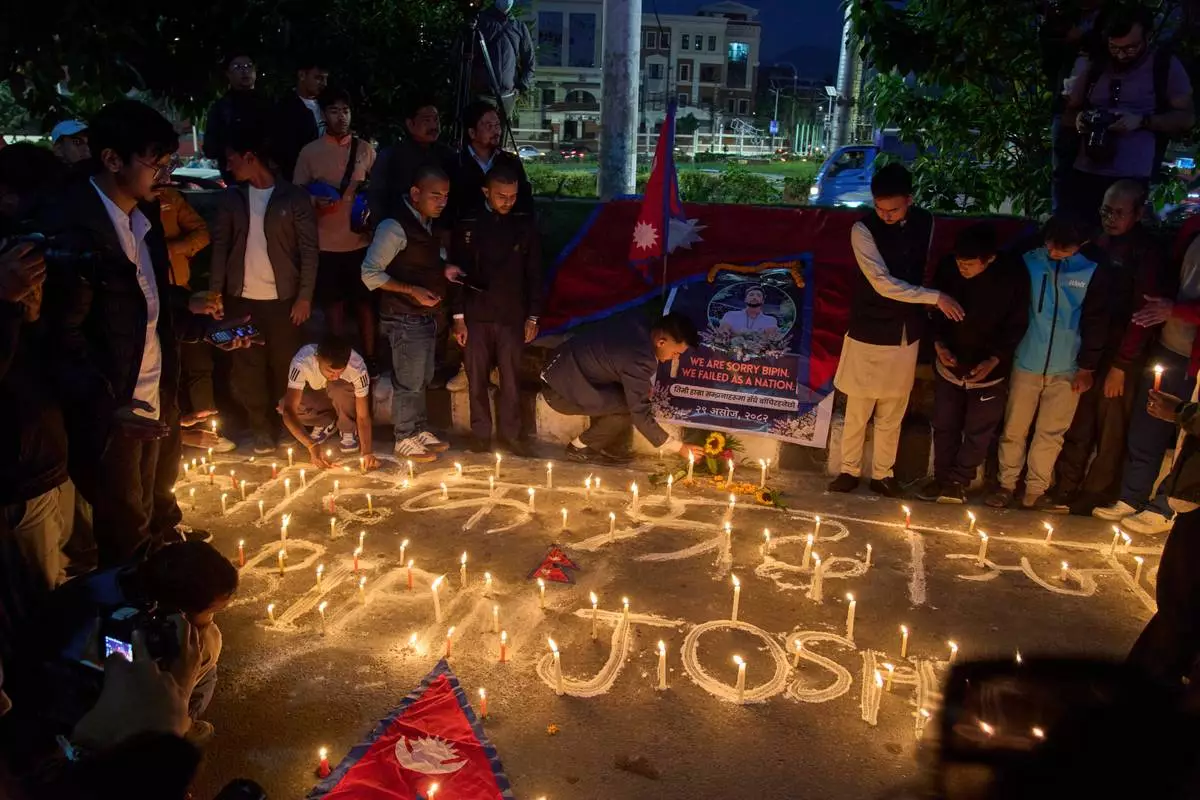 People participate in a candlelight vigil for Bipin Joshi, a Nepali man who was taken hostage by Hamas on Oct. 7, 2023, and was recently declared dead, in Kathmandu, Nepal, Wednesday, Oct. 15, 2025. (AP Photo/Niranjan Shrestha)