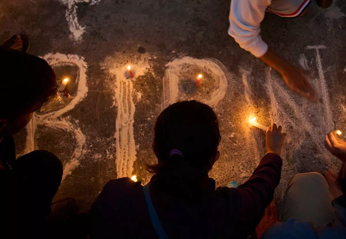 People participate in a candlelight vigil for Bipin Joshi, a Nepali man who was taken hostage by Hamas on Oct. 7, 2023, and was recently declared dead, in Kathmandu, Nepal, Wednesday, Oct. 15, 2025. (AP Photo/Niranjan Shrestha)