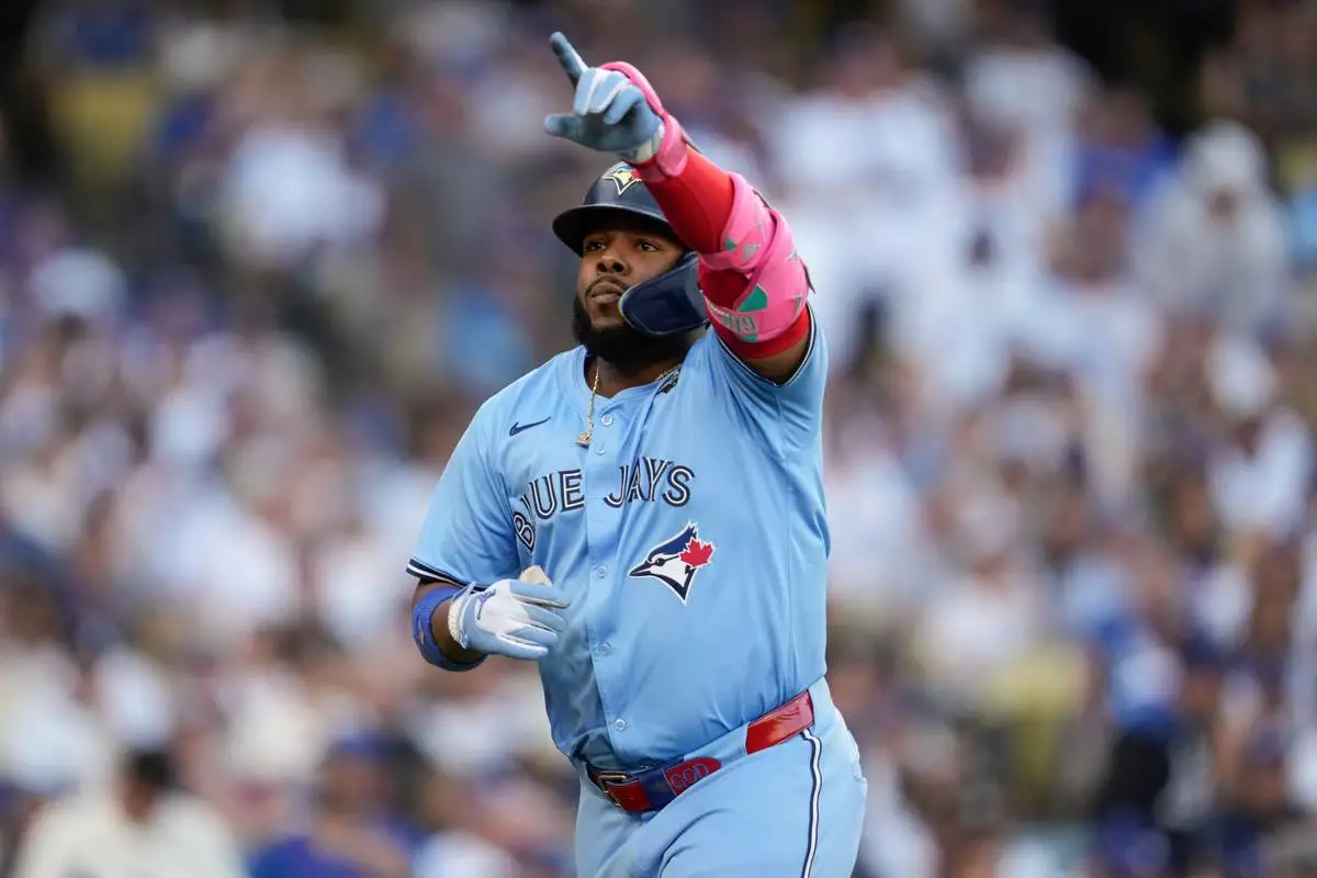 Toronto Blue Jays' Vladimir Guerrero Jr. celebrates his solo home run during the first inning in Game 5 of baseball's World Series against the Los Angeles Dodgers, Wednesday, Oct. 29, 2025, in Los Angeles. (AP Photo/Ashley Landis)