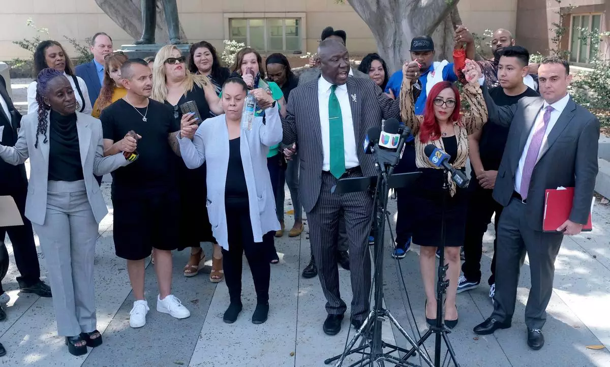 FILE - Attorney Ben Crump, center, leads a chant with attorney Adam Slater, far right, during a news conference with survivors of sexual abuse that occurred at MacLaren Hall, June 9, 2022 in Los Angeles. (Dean Musgrove/The Orange County Register via AP, File)