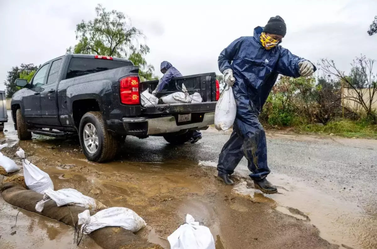 Atmospheric river hits Southern California with risks of flash floods and deaths on stormy seas