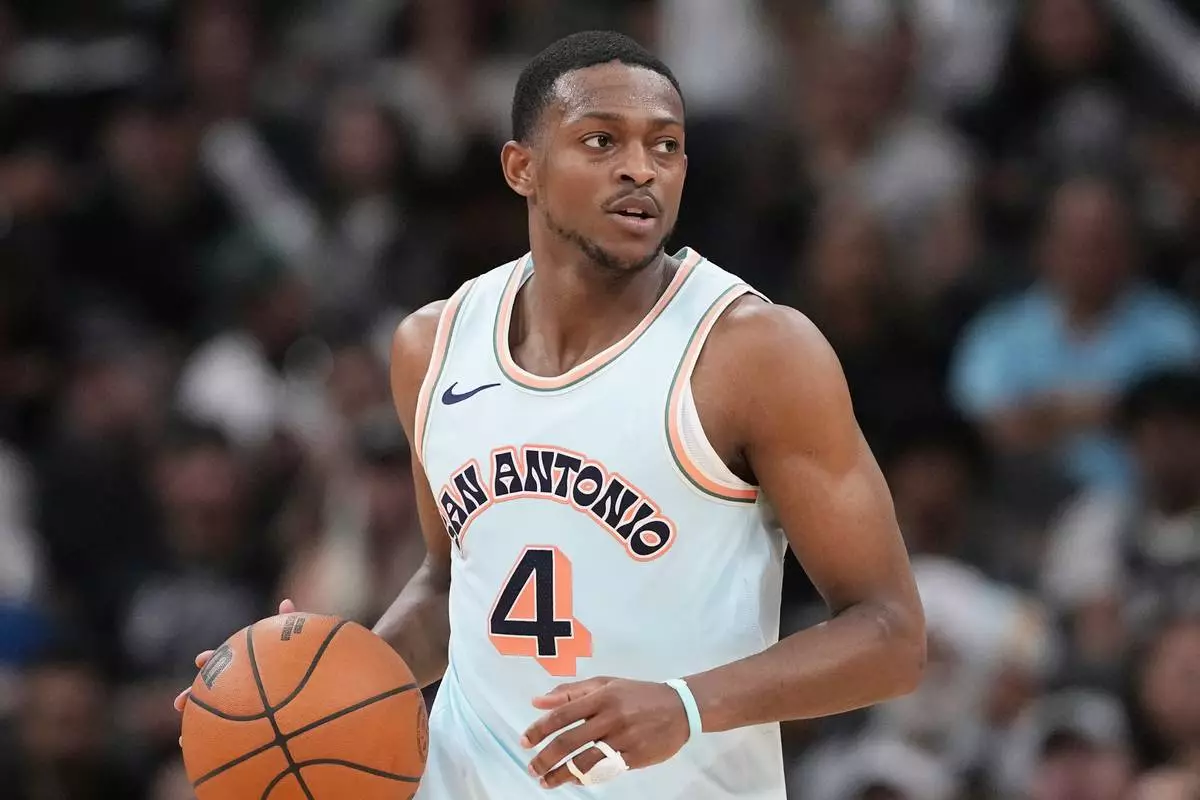 FILE - San Antonio Spurs guard De'Aaron Fox (4) during the second half of an NBA basketball game against the Dallas Mavericks in San Antonio, Wednesday, March 12, 2025. (AP Photo/Eric Gay, File)