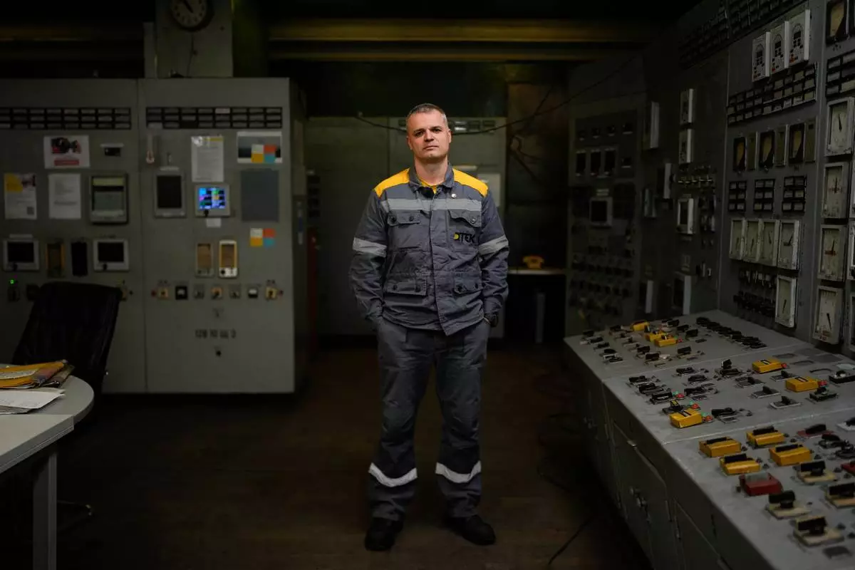 Mykhailo, 45, a senior power unit engineer, who declined to give his surname due to security concerns, poses for a portrait in the control room of a Ukrainian thermal power plant, Wednesday, Oct. 29, 2025. "If all the turbine operators hid during attacks, there'd be no energy left," he says. "We have to stay at our posts. Who else would do the job?" (AP Photo/Julia Demaree Nikhinson)