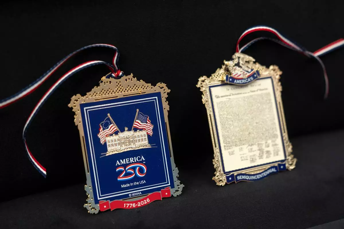 The front and back of a commemorative ornament released by America250 as part of events leading up to the 250th anniversary of the signing of the Declaration of Independence in 1776, is photographed Thursday, Nov. 13, 2025, in Washington. (AP Photo/Mark Schiefelbein)
