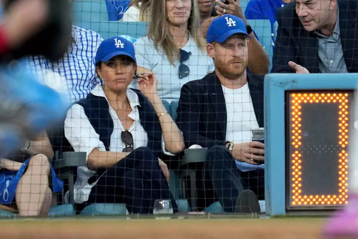 Prince Harry and Meghan Markle watch during the second inning in Game 4 of baseball's World Series between the Los Angeles Dodgers and the Toronto Blue Jays, Tuesday, Oct. 28, 2025, in Los Angeles. (AP Photo/Ashley Landis)