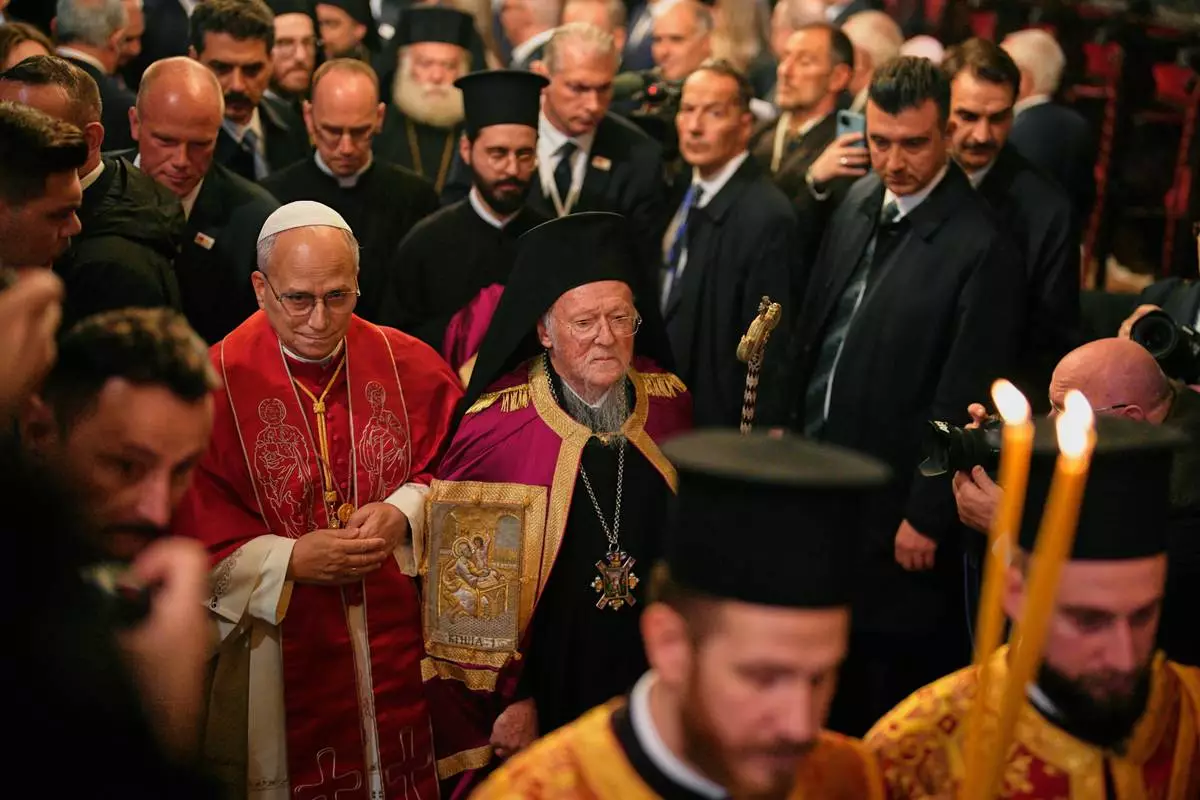 Pope Leo XIV and Ecumenical Patriarch Bartholomew I, the spiritual leader of the world's Eastern Orthodox Christians leave after attending the Doxology at the Patriarchal Church of Saint George, in Istanbul, Turkey, Saturday, Nov. 29, 2025. (AP Photo/Emrah Gurel)