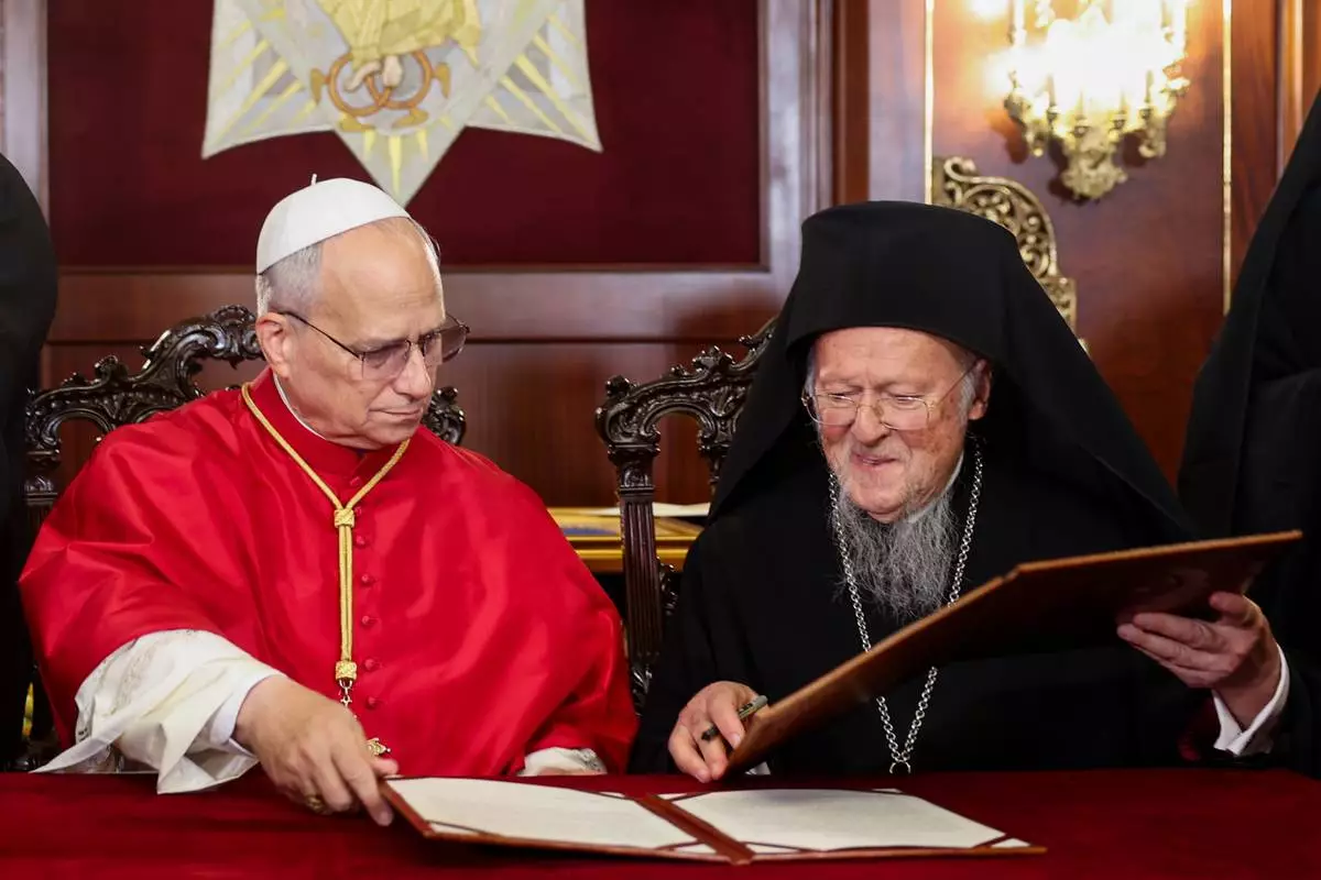 Pope Leo XIV and Ecumenical Patriarch Bartholomew I sign a joint declaration at the Ecumenical Patriarchate, during Pope's first apostolic journey, in Istanbul, Turkey, November 29, 2025. (Dilara Senkaya/Pool Via AP)
