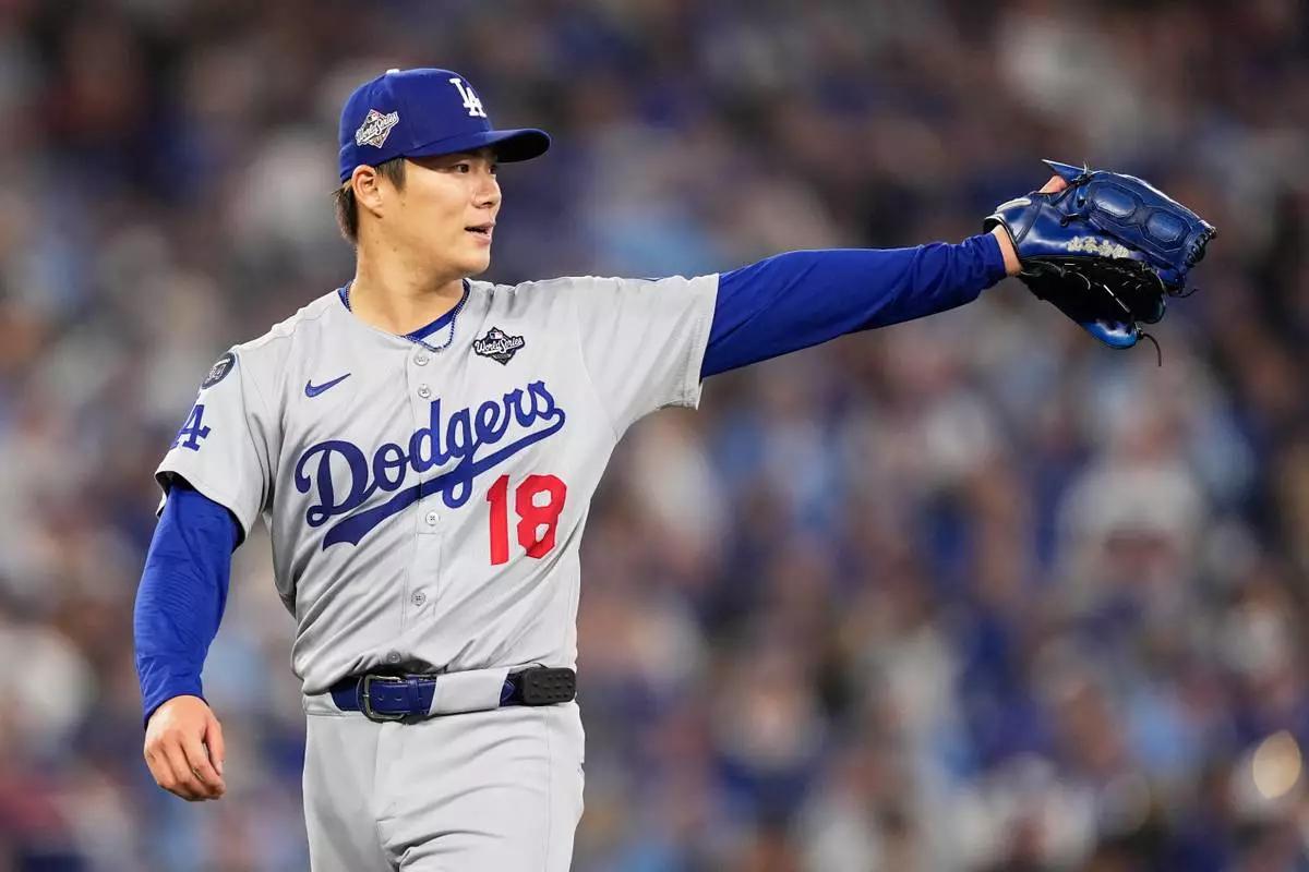 Los Angeles Dodgers pitcher Yoshinobu Yamamoto gestures during the fourth inning in Game 6 of baseball's World Series against the Toronto Blue Jays, Friday, Oct. 31, 2025, in Toronto. (AP Photo/Brynn Anderson)