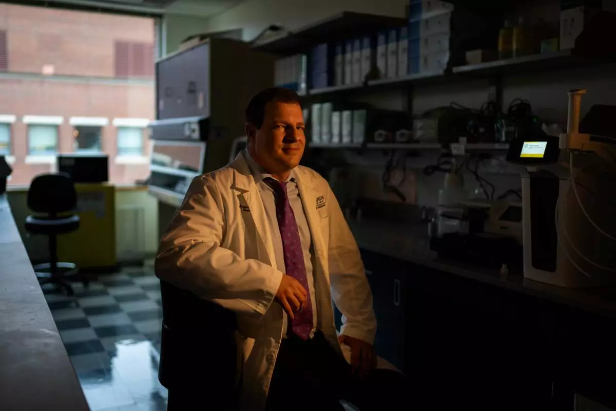 Dr. Maximilian Konig, a rheumatologist at Johns Hopkins University, sits for a portrait in the lab where he's studying some possible new treatments for autoimmune diseases, Tuesday, May 13, 2025, in Baltimore, Md. (AP Photo/David Goldman)