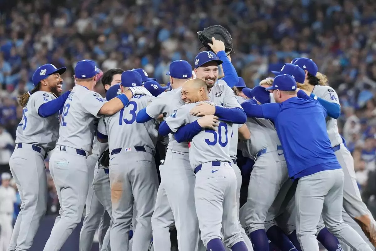 Los Angeles Dodgers players celebrate after defeating the Toronto Blue Jays in Game 7 of baseball's World Series, Sunday, Nov. 2, 2025, in Toronto. (Nathan Denette/The Canadian Press via AP)