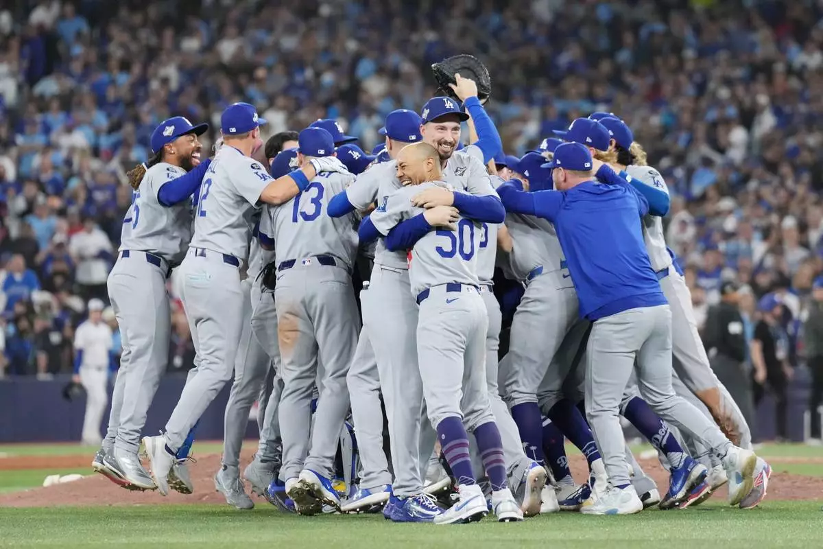 Los Angeles Dodgers players celebrate after defeating the Toronto Blue Jays in Game 7 of baseball's World Series, Sunday, Nov. 2, 2025, in Toronto. (Nathan Denette/The Canadian Press via AP)
