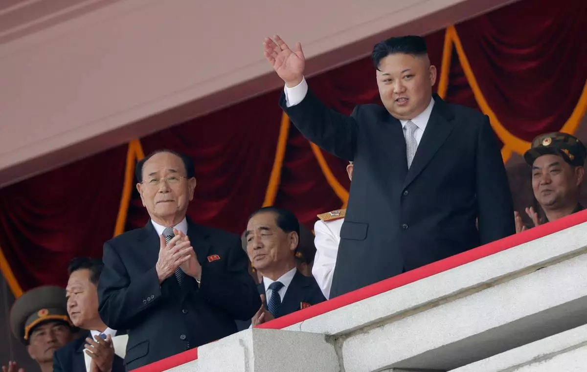 FILE - North Korean leader Kim Jong Un, right, waves while Kim Yong Nam, third left, Choe Ryong Hae, second left, and Pak Pong Ju, center, clap during a military parade April 15, 2017, in Pyongyang, North Korea to celebrate the 105th birth anniversary of Kim Il Sung, the country's late founder and grandfather of current ruler Kim Jong Un. (AP Photo/Wong Maye-E, File)