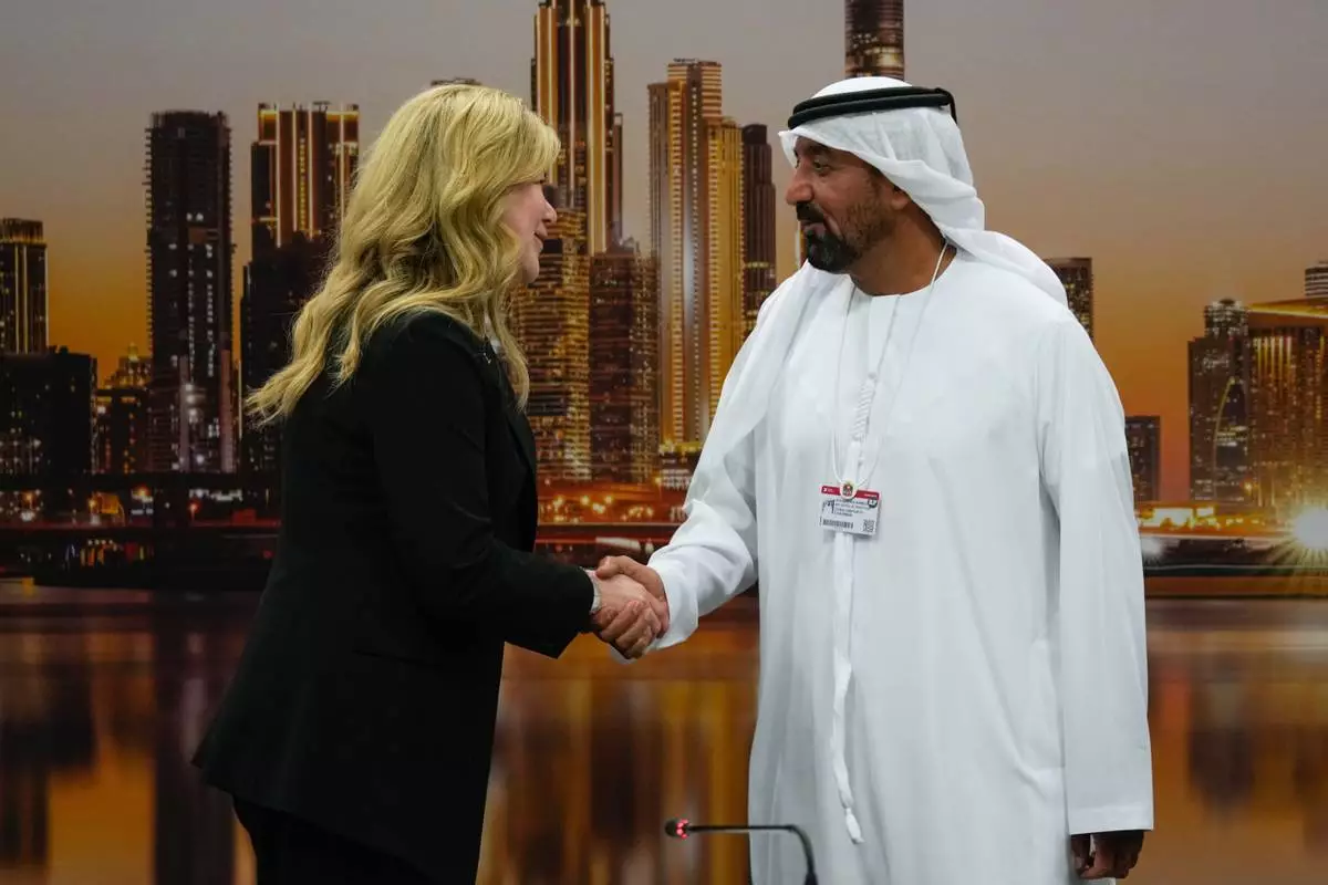 Stephanie Pope, President and CEO of Boeing Commercial Airplanes, left, and Sheikh Ahmed bin Saeed Al Maktoum, President, Dubai Civil Aviation Authority and Chairman of Emirates airlines, shake hands after signing an agreement to order 65 additional Boeing 777X aircrafts during a press conference on the opening day of the Dubai Air Show, United Arab Emirates, Monday, Nov. 17, 2025. (AP Photo/Altaf Qadri)