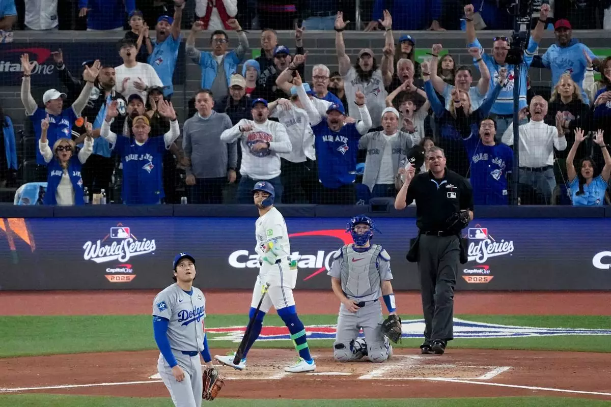 Toronto Blue Jays' Bo Bichette watches his three run home run off Los Angeles Dodgers' Shohei Ohtani leave the park during the third inning in Game 7 of baseball's World Series, Saturday, Nov. 1, 2025, in Toronto. (AP Photo/Ashley Landis)