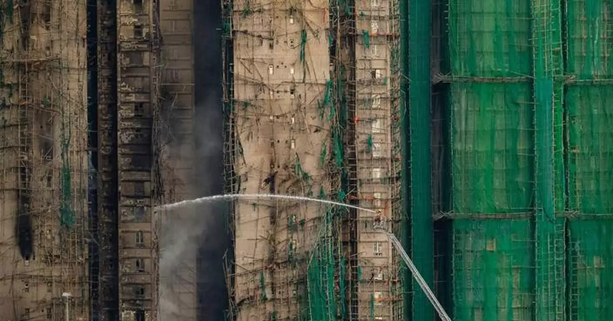 At least 75 dead as Hong Kong firefighters battle burning towers for a second day