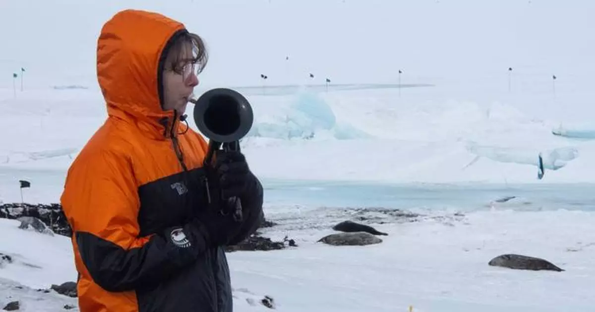 On the world’s coldest stage, a military musician plays with a plastic horn and double gloves