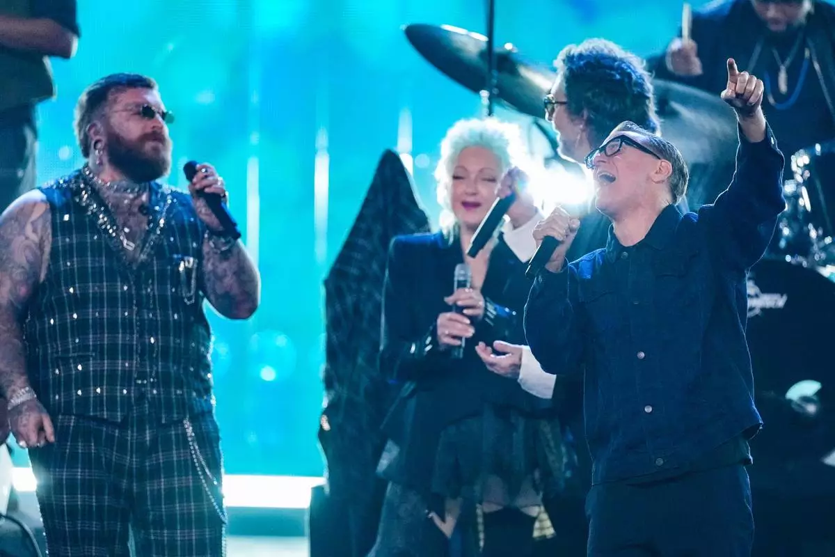 Teddy Swims, from left, Cyndi Lauper and Bryan Adams perform during the 2025 Rock and Roll Hall of Fame Induction Ceremony on Saturday, Nov. 8, 2025, at L.A. Live in Los Angeles. (AP Photo/Chris Pizzello)