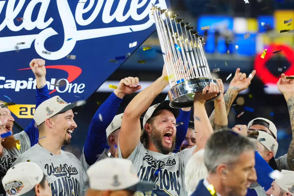 Los Angeles Dodgers pitcher Clayton Kershaw lifts the trophy after the Dodgers defeated the Toronto Blue Jays in Game 7 of baseball's World Series, Sunday, Nov. 2, 2025, in Toronto. (Frank Gunn/The Canadian Press via AP)