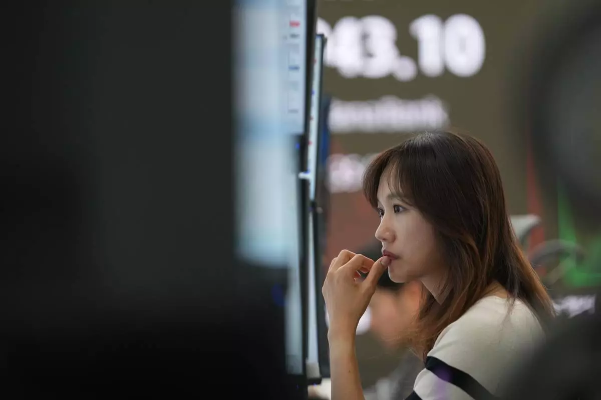 A dealer watches computer monitors at a dealing room of Hana Bank in Seoul, South Korea, Friday, Nov. 7, 2025. (AP Photo/Lee Jin-man)