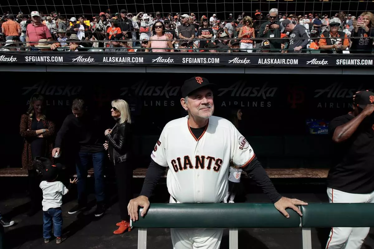 FILE - San Francisco Giants manager Bruce Bochy stands in the dugout before a baseball game between the Giants and the Los Angeles Dodgers in San Francisco, Sept. 29, 2019. (AP Photo/Jeff Chiu, File)