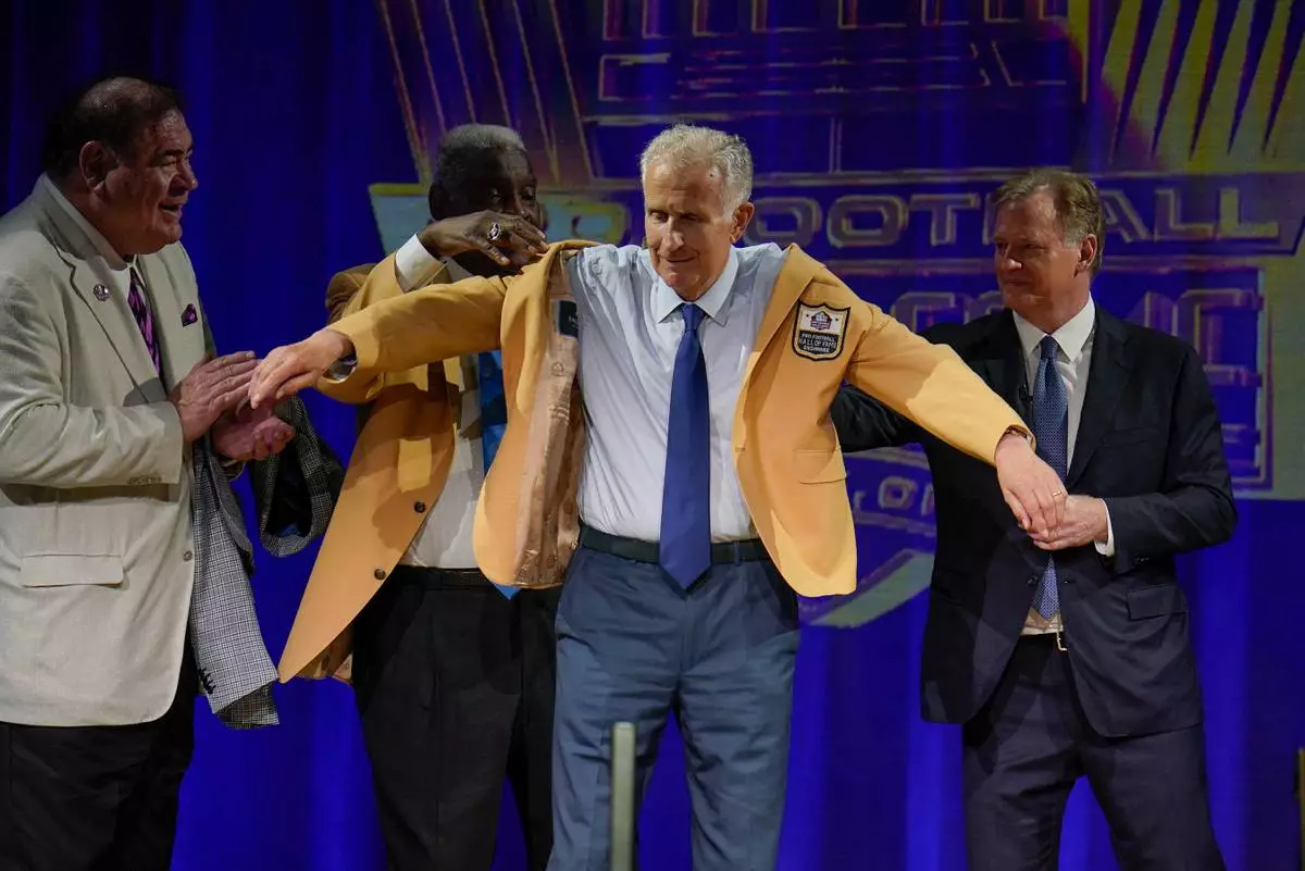 FILE - Paul Tagliabue, a member of the Pro Football Hall of Fame Centennial Class, receives his gold jacket during the gold jacket dinner in Canton, Ohio, Aug. 6, 2021. (AP Photo/Gene J. Puskar, File)
