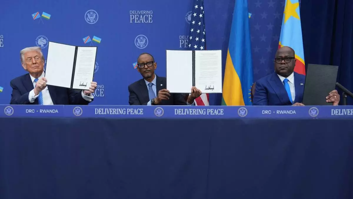 President Donald Trump, Rwanda's President Paul Kagame and Democratic Republic of Congo President Felix-Antoine Tshisekedi, during a signing ceremony at the Donald J. Trump Institute of Peace, Thursday, Dec. 4, 2025, in Washington. (AP Photo/Evan Vucci)