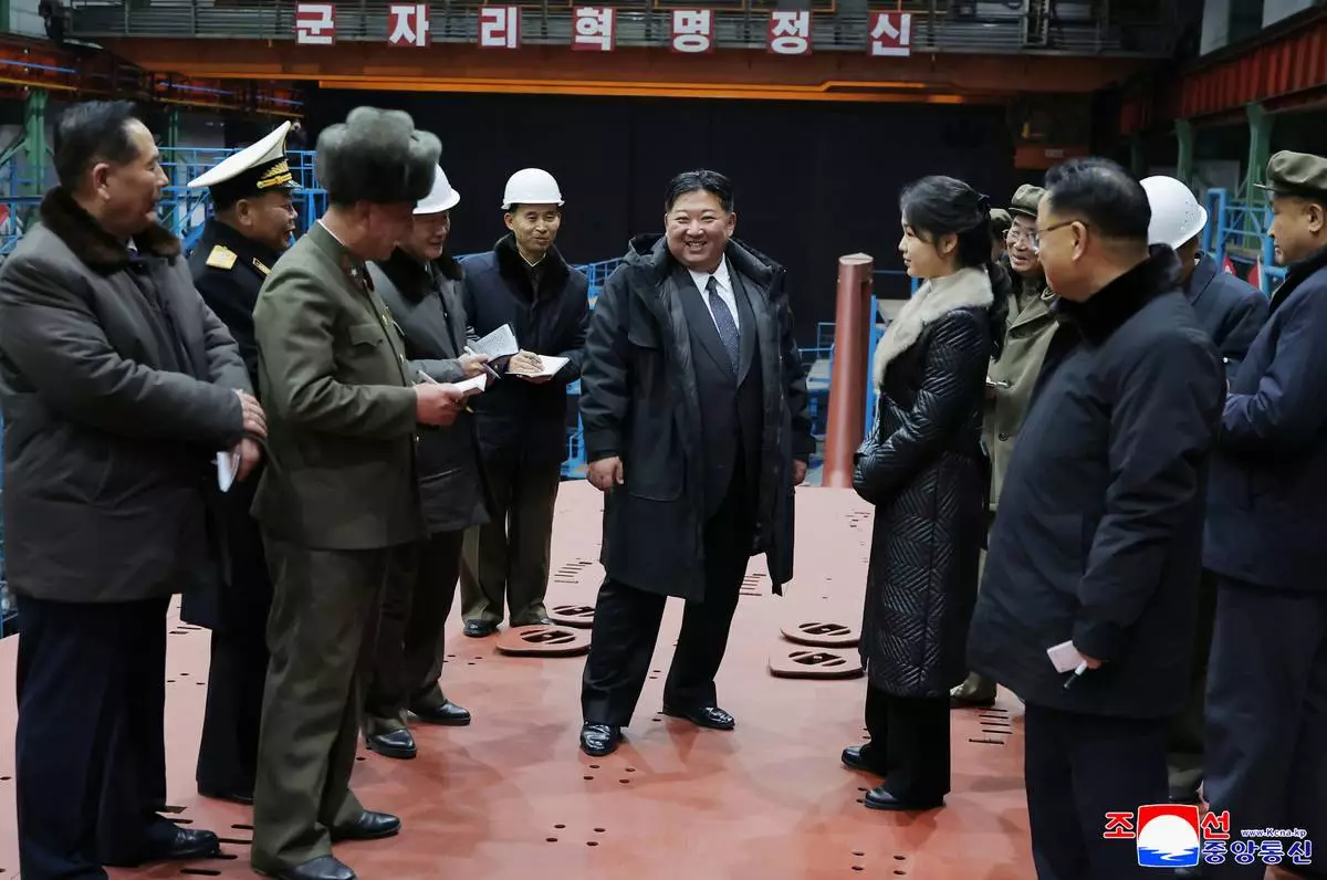 In this undated photo provided Thursday, Dec. 25, 2025, by the North Korean government, its leader Kim Jong Un, with his daughter, inspects a nuclear-powered submarine under construction at an undisclosed location in North Korea. Independent journalists were not given access to cover the event depicted in this image distributed by the North Korean government. The content of this image is as provided and cannot be independently verified. Korean language watermark on image as provided by source reads: "KCNA" which is the abbreviation for Korean Central News Agency. (Korean Central News Agency/Korea News Service via AP)