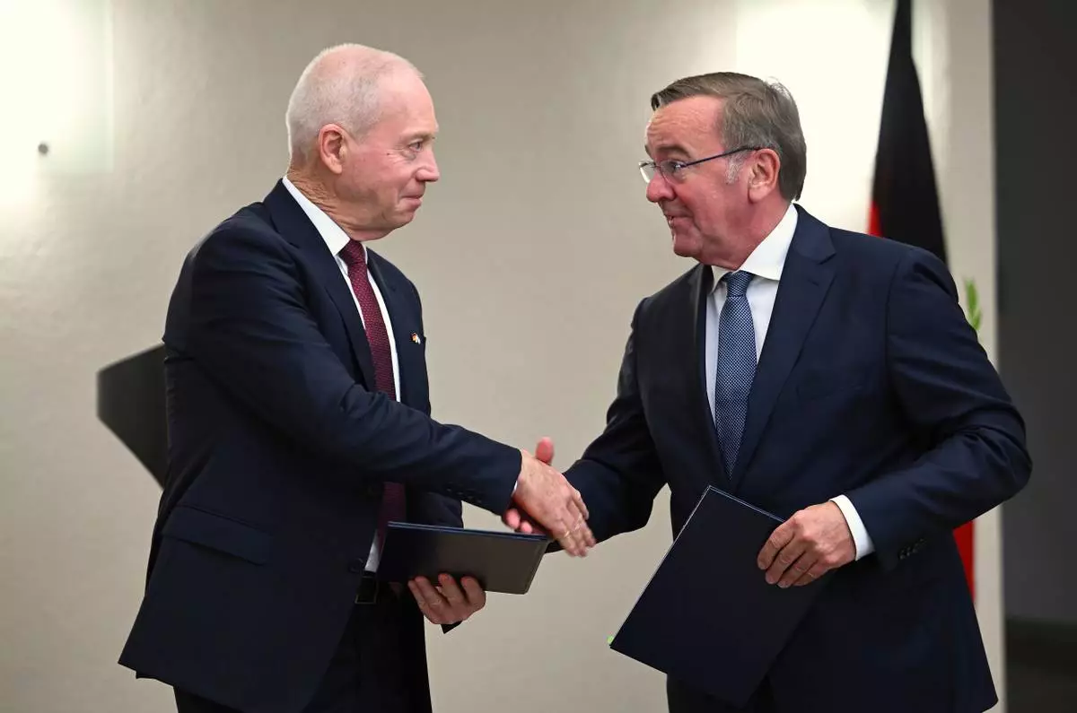 FILE - German Federal Minister of Defense Boris Pistorius, right, and his then counterpart from Isreal, Joav Galant, left, shake hands in Berlin, Germany, Thursday Sept. 28. 2023 after signing a contract to purchase the Arrow 3 missile defense system. (Britta Pedersen/dpa via AP, File)