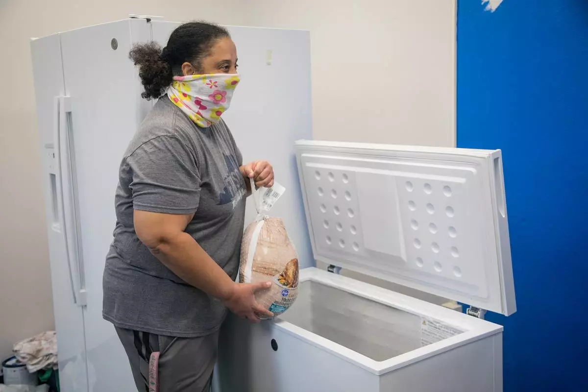 GE Appliances employees placing donated frozen food into a community freezer to support local families. (Photo: GE Appliances, a Haier company)
