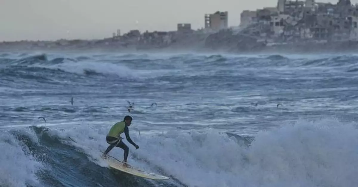 Photos show surfers riding waves along Gaza City’s damaged coastline