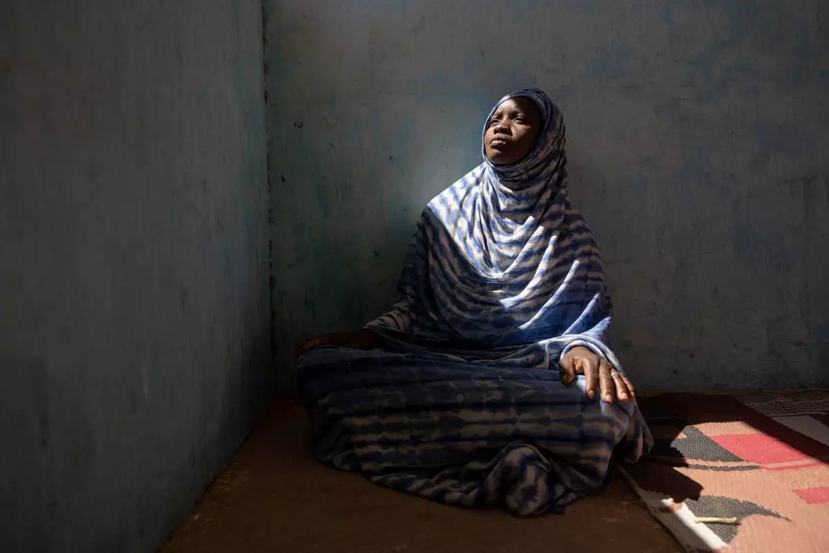 Moyme, who fled Mali in fear of the Malian Army and its Russian allies, poses for a portrait Tuesday, Nov. 4, 2025, in a camp in Mbera, Mauritania where she has found refuge. (AP Photo/Caitlin Kelly)