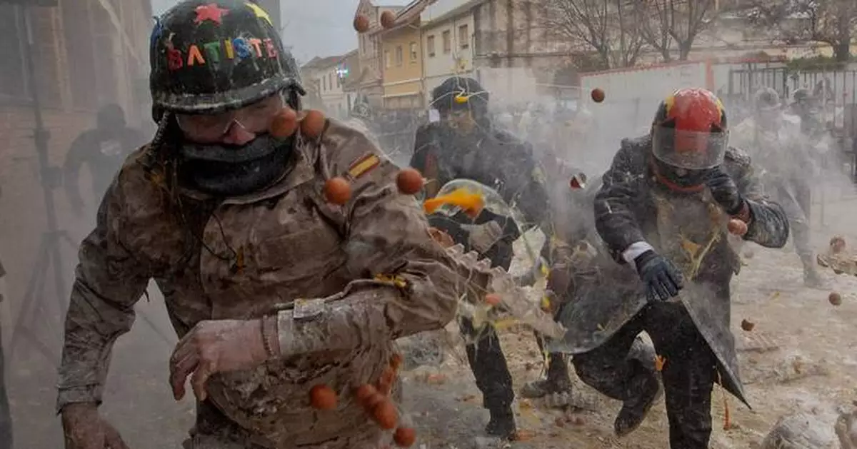 Photos show flour, eggs and firecrackers flying at Spain's Els Enfarinats festival