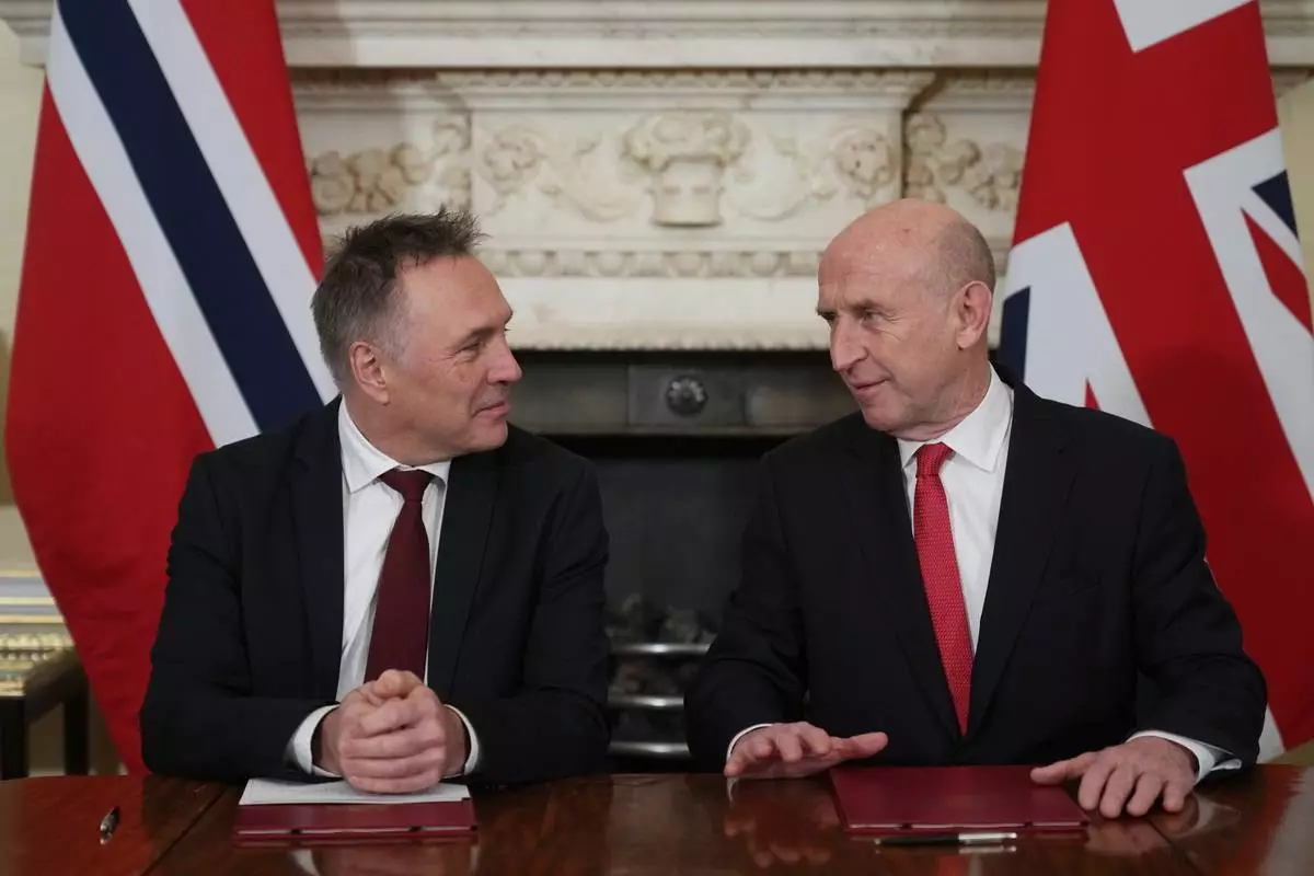 Norway's Minister of Defence Tore O. Sandvik, left, and Britain's Secretary of State for Defence John Healey during the signing of a Strategic Defence Agreement in London, Thursday, Dec. 4, 2025. (AP Photo/Alastair Grant, pool)