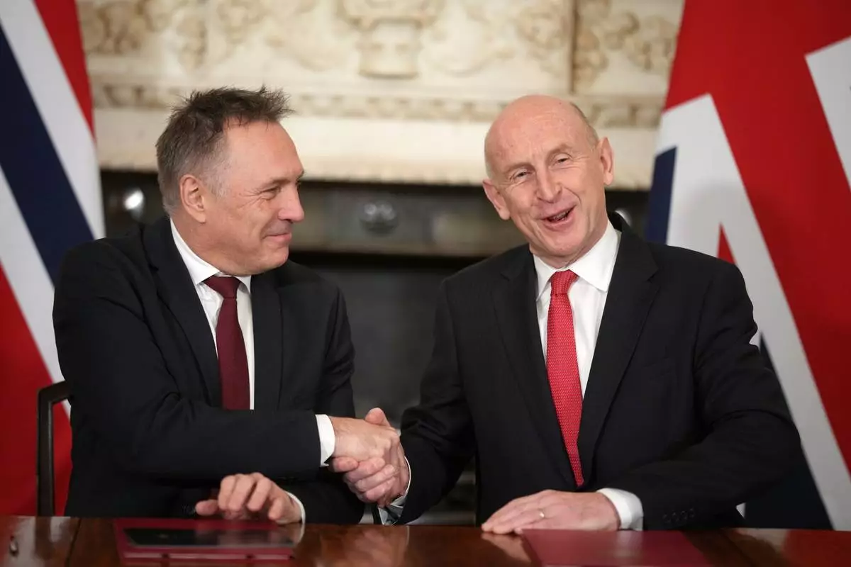 Norway's Minister of Defence Tore O. Sandvik, left, and Britain's Secretary of State for Defence John Healey shake hands during the signing of a Strategic Defence Agreement in Downing Street in London, Thursday, Dec. 4, 2025. (AP Photo/Alastair Grant, pool)