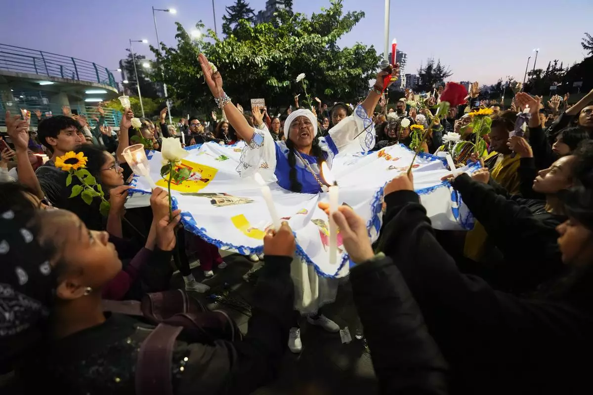 FILE - People take part in a ceremony marking the anniversary of the murder of four children by the military in Guayaquil, Quito, Ecuador, Monday, Dec. 8, 2025. (AP Photo/Dolores Ochoa, File)