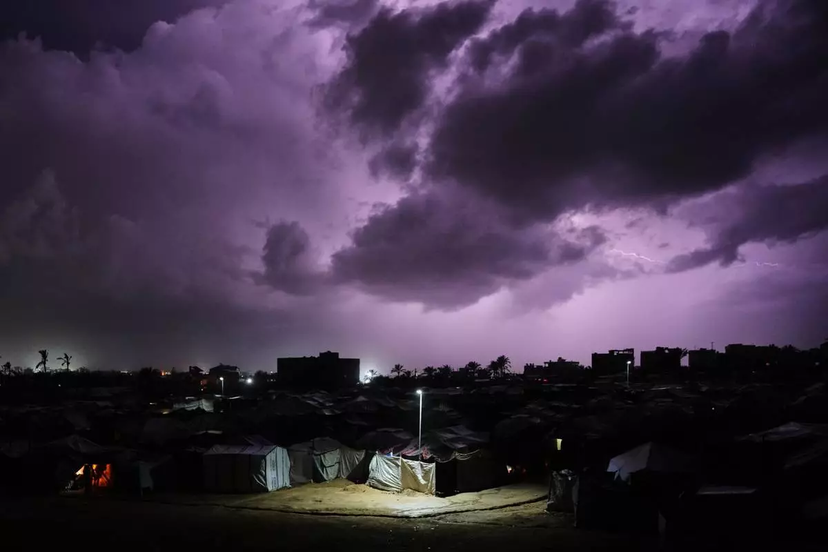 FILE - A thunderstorm rolls over a tent camp for displaced Palestinians in Zawaida, central Gaza Strip, Wednesday, Dec. 10, 2025. (AP Photo/Abdel Kareem Hana, File)
