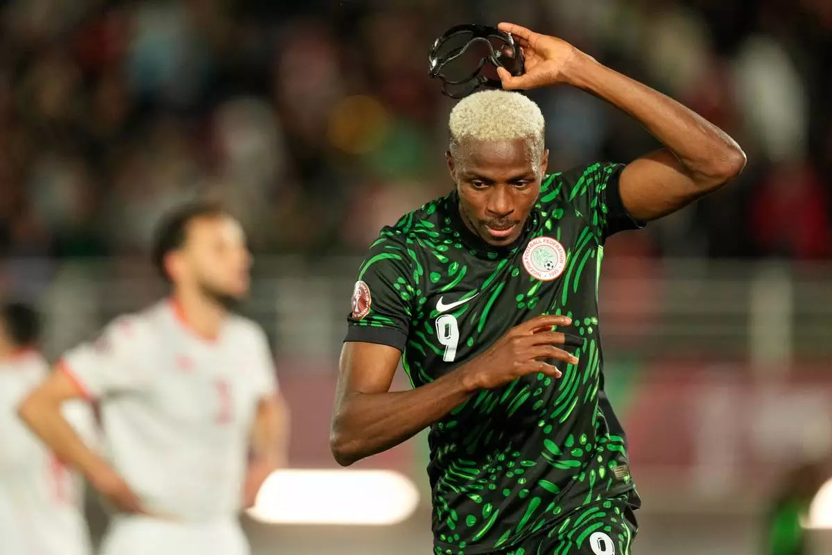 Nigeria's Victor Osimhen reacts after scoring his side's first goal during the Africa Cup of Nations group C soccer match between Nigeria and Tunisia in Fez, Morocco, Saturday, Dec. 27, 2025. (AP Photo/Mosa'ab Elshamy)