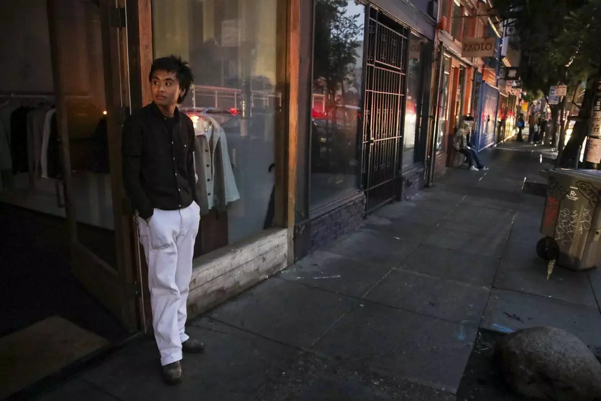 Ryan Sicat, store manager of Industry of All Nations, stands outside the store after a major power outage in San Francisco, Saturday, Dec. 20, 2025. (Yalonda M. James/San Francisco Chronicle via AP)