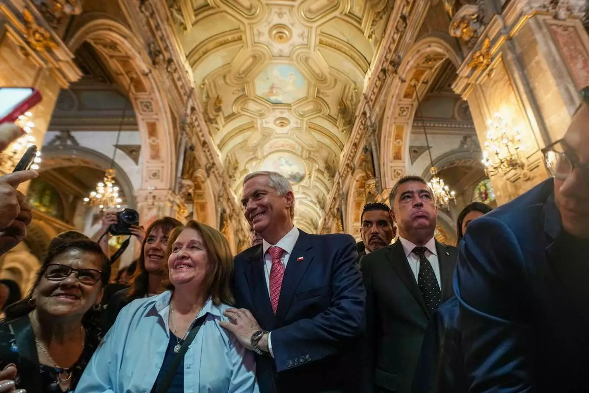 Chilean President-elect Jose Antonio Kast and his wife Maria Pia Adriasola greet supporters at the Santiago Cathedral after attending Mass in Santiago, Chile, Friday, Dec. 19, 2025. (AP Photo/Esteban Felix)