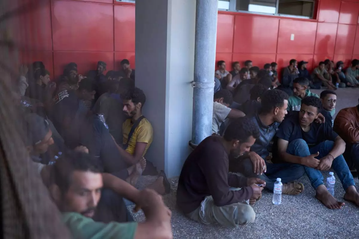 FILE - Migrants rescued south of Crete wait to be registered on their arrival at the the port of Lavrio, Greece, on Thursday, July 10, 2025. (AP Photo/Petros Giannakouris, file)