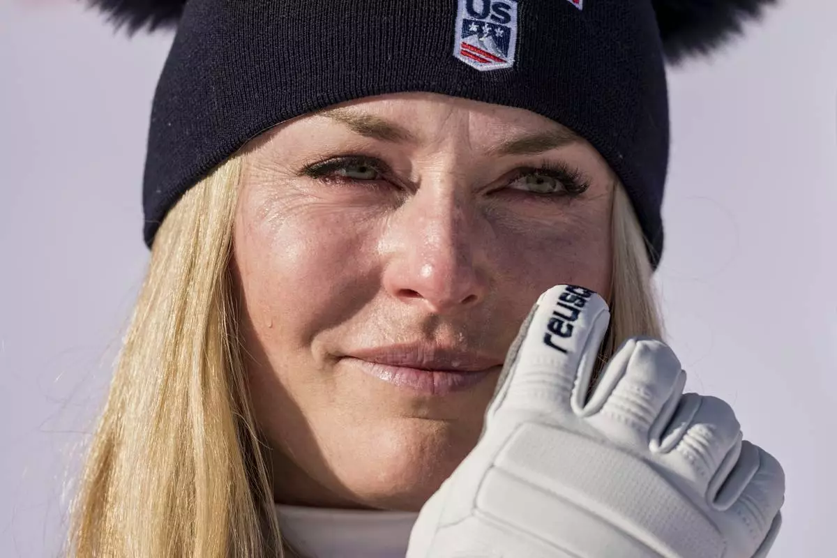 United States' Lindsey Vonn gets emotional as she celebrates winning an alpine ski, women's World Cup downhill, in St. Moritz, Switzerland, Friday Dec. 12, 2025. (Claudio Thoma/Keystone via AP)