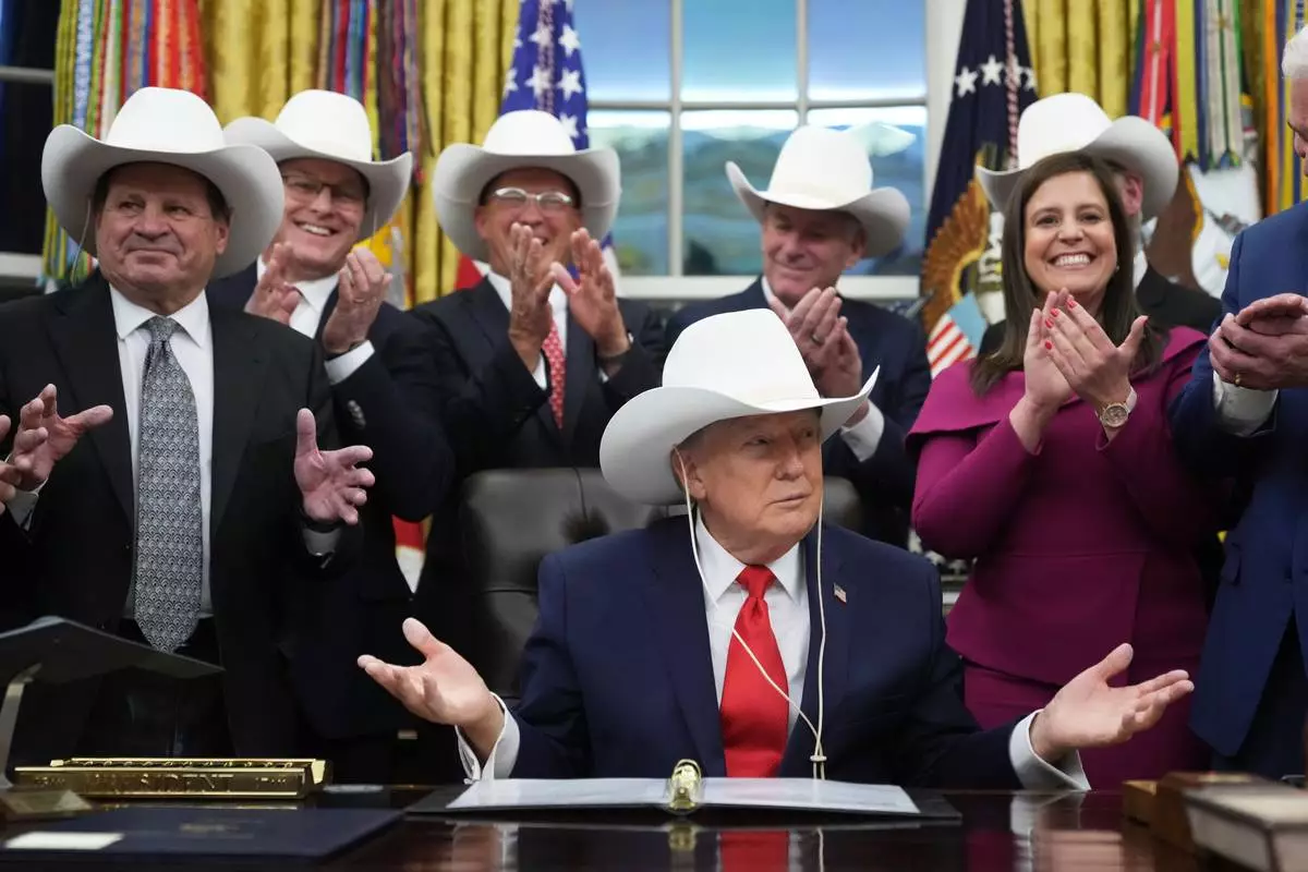 President Donald Trump attends a bill signing ceremony with members of the 1980 U.S. Men's Olympic Hockey team, Friday, Dec. 12, 2025, in the Oval Office of the White House, in Washington. (AP Photo/Jacquelyn Martin)