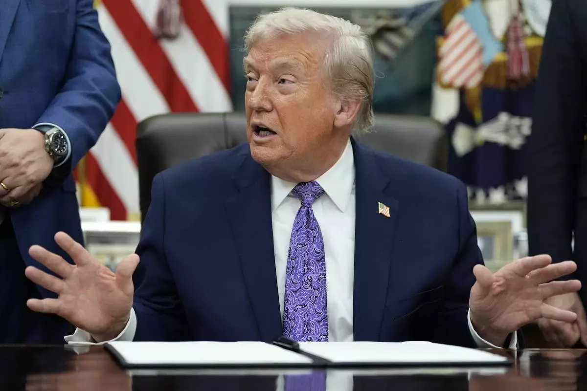 President Donald Trump gestures during a signing ceremony on an AI initiative in the Oval Office of the White House, Thursday, Dec. 11, 2025, in Washington. (AP Photo/Alex Brandon)