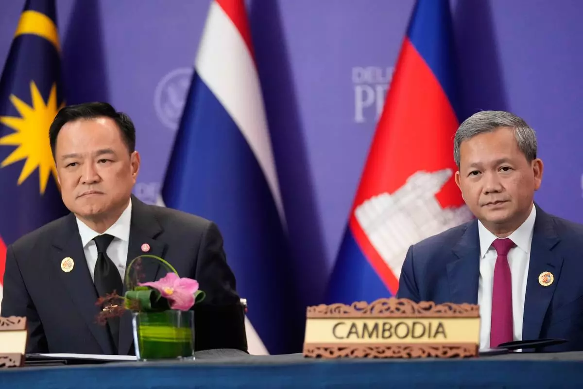 FILE - Cambodian Prime Minister Hun Manet, right, and Thailand's Prime Minister Anutin Charnvirakul, left, react during a signing ceremony on the sidelines of the ASEAN Summit in Kuala Lumpur, Malaysia, Sunday, Oct. 26, 2025. (AP Photo/Mark Schiefelbein, File)