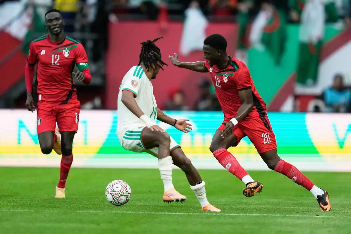 Sudan's Abo Eisa, right, challenges for the ball with Algeria's Hicham Boudaoui during the Africa Cup of Nations group E soccer match between Algeria and Sudan in Rabat, Morocco, Wednesday, Dec. 24, 2025. (AP Photo/Mosa'ab Elshamy)